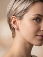 model A fine pair of cluster earrings. Features to the centre a round 4.6mm pink sapphire (est 0.38 carats) with a good deep colour hue.