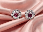 A fine pair of cluster earrings. Features to the centre a round 4.6mm pink sapphire  with a good deep colour hue.