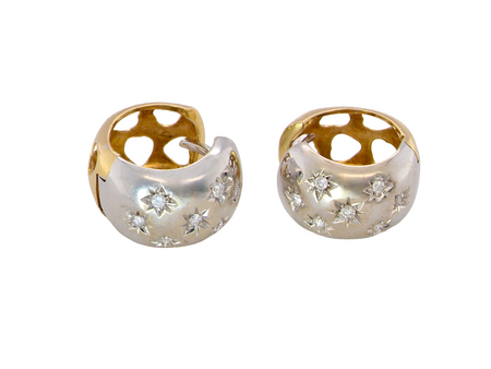 A fine pair of cuff style hoop earrings. The front part is 18 carat white gold * set with seven small white diamonds, 