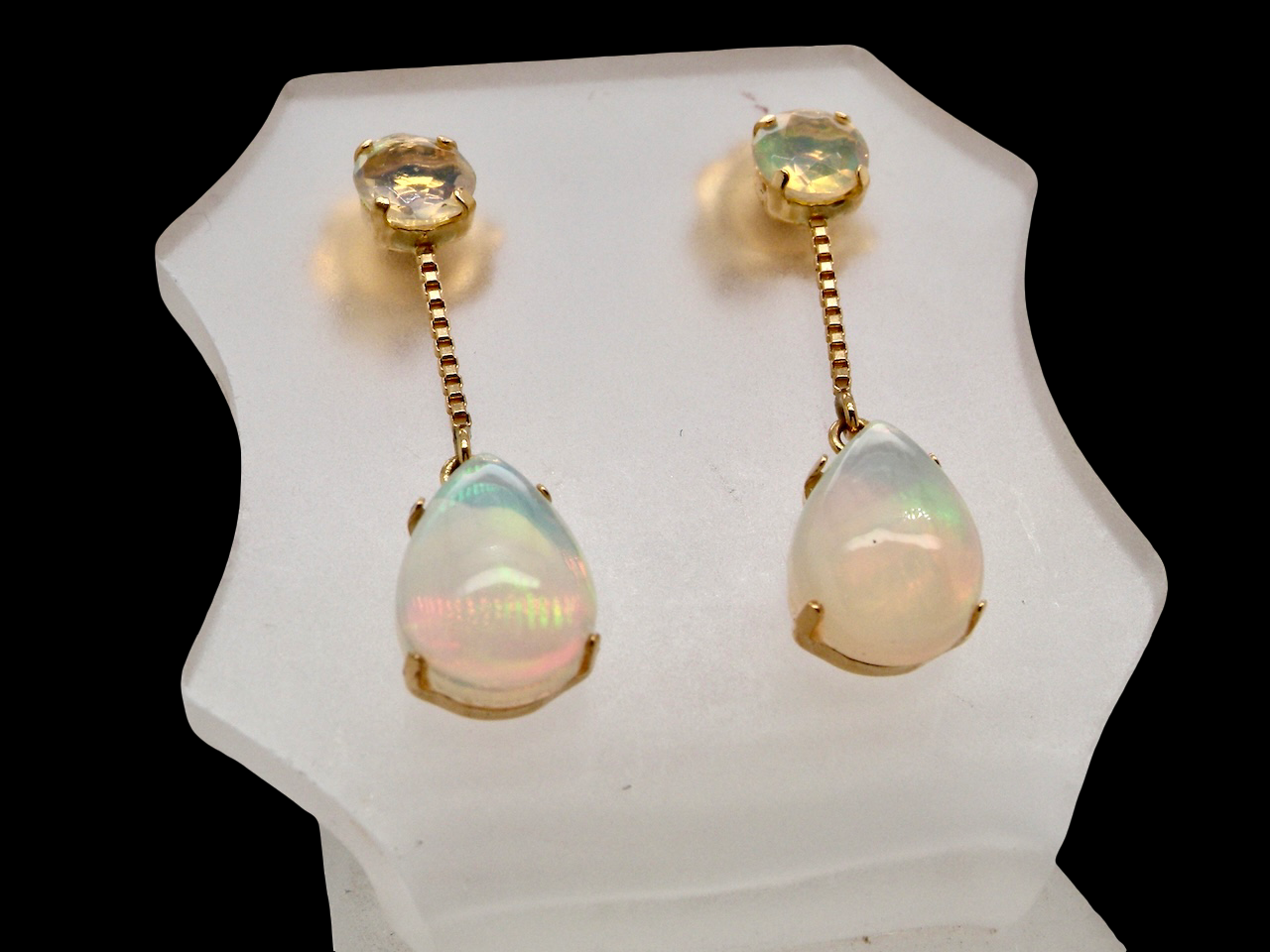  Suspending from a round opal which is at the head of the post, (measures 4mm) a pear shaped opal 8x6mm, and attached to a 9mm box link chain.
