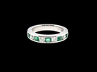 A fine platinum half hoop eternity ring. This is a new ring*. Channel set gem stones, five bright green emeralds 2.6mm each