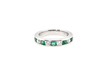 A fine platinum half hoop eternity ring. This is a new ring*. Channel set gem stones, five bright green emeralds 2.6mm each (0.54 carats total)