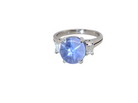 A fine platinum* ring. Features a lovely sky blue sapphire with 'star sapphire ' chatoyancy , measures 10x9mm, (est 4 carats) held by four claws, cabouchon cut