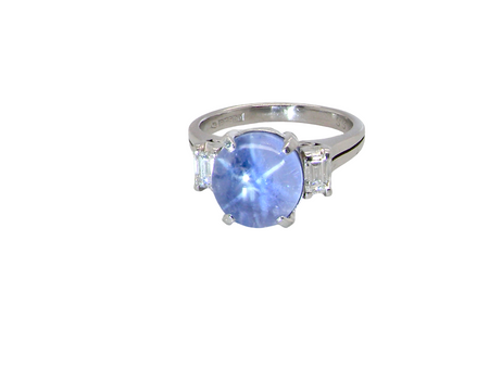 A fine platinum* ring. Features a lovely sky blue sapphire with 'star sapphire ' chatoyancy , measures 10x9mm, (est 4 carats) held by four claws, cabouchon cut