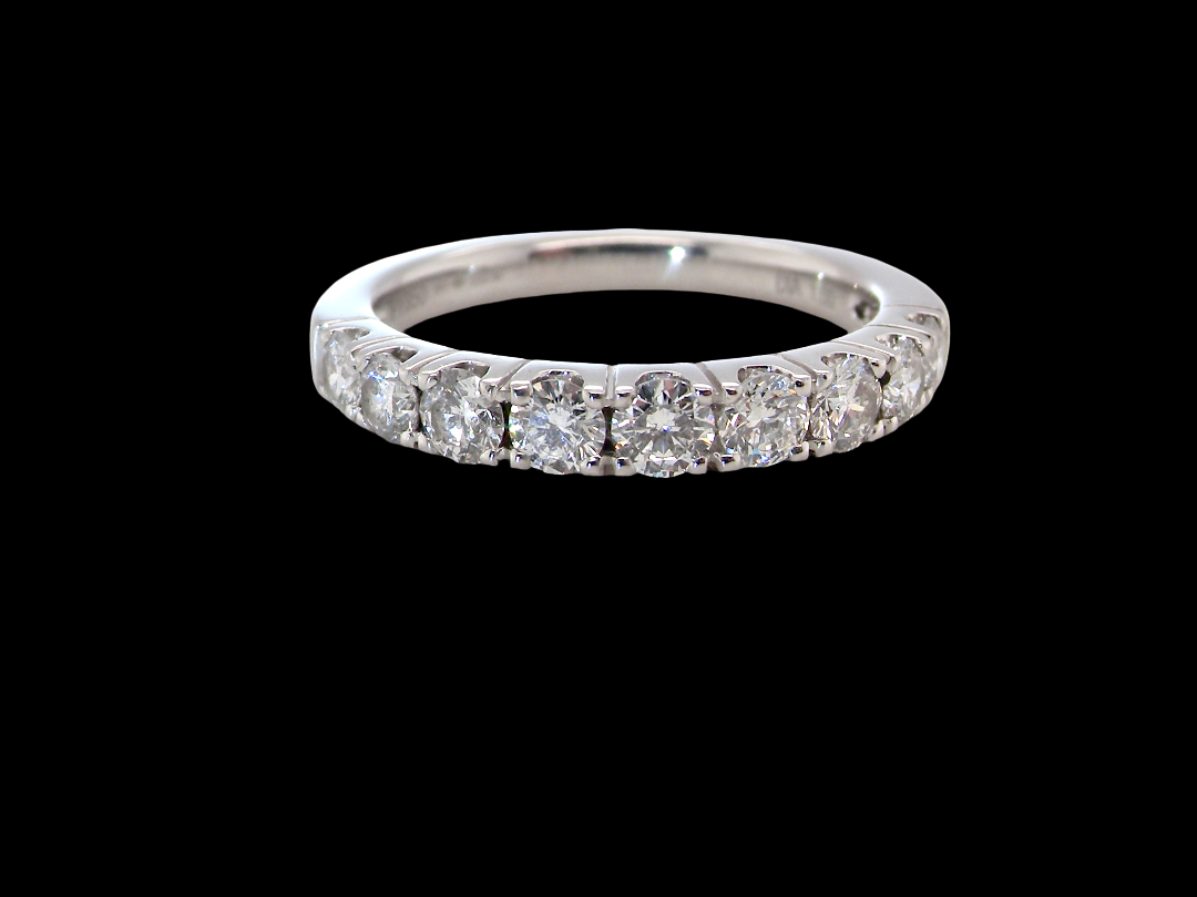 A fine seven stone half hoop platinum eternity ring,