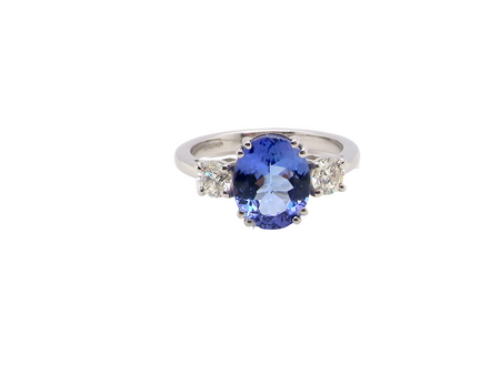 A fine three stone trilogy ring. The centre stone a 4A tanzanite gem stone, measures 10x8mm (est 3 carats)&nbsp;