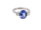A fine three stone trilogy ring. The centre stone a 4A tanzanite gem stone, measures 10x8mm &nbsp;