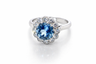 A fine vintage cluster ring centred with a deep blue aquamarine, measuring approximately 8mm and estimated at 2 carats, securely claw set.