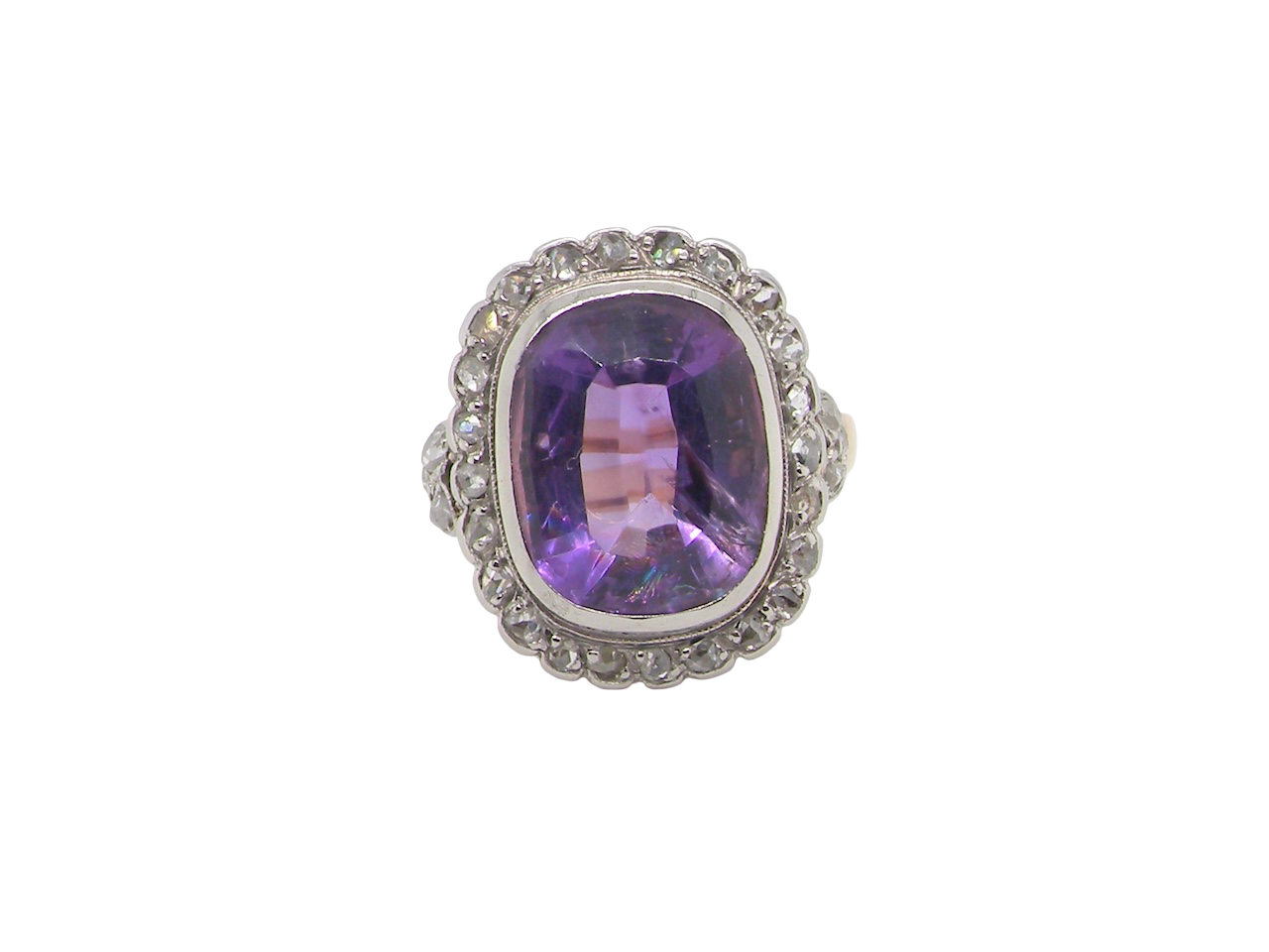 A fine vintage ring. Features to the centre a large cushion shaped amethyst, 13x10mm, rim setting.
