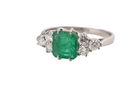 A fine white gold* ring that features a rectangular emerald centre stone, measures 6x6.5mm (est one carat), mid to dark green hue,