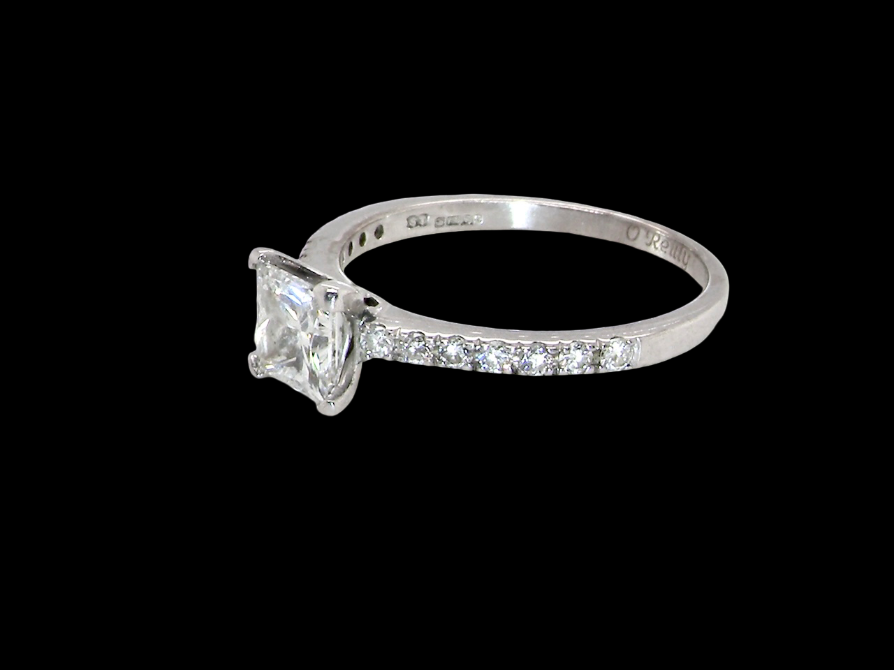 Diamond ring with a clear gemstone on a black background