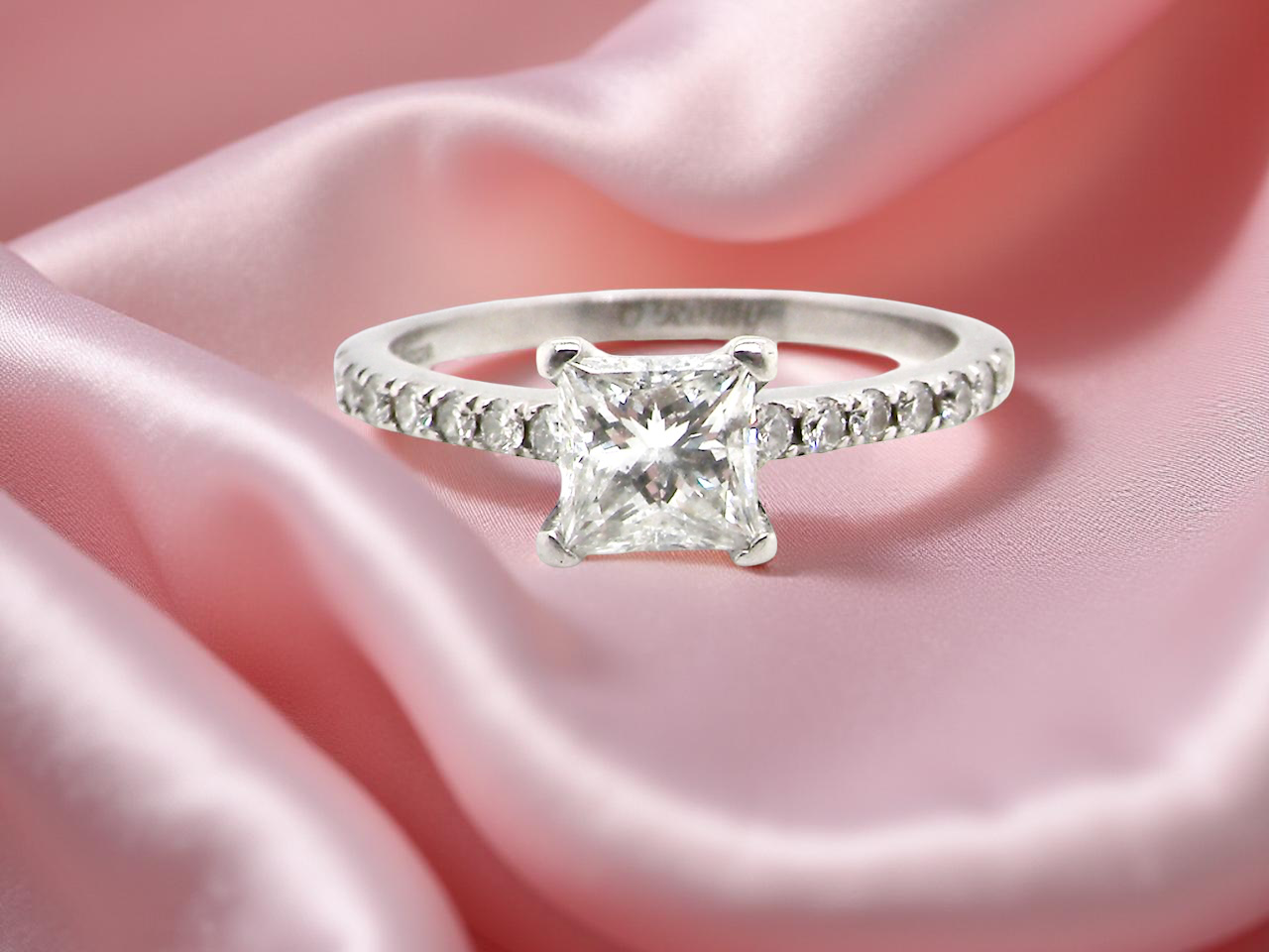 Diamond ring on pink satin fabric