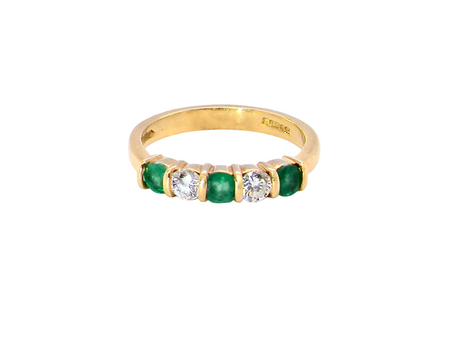 A five stone ring set with three emeralds, each 3mm diameter.

Between each two brilliant cut white diamonds, each 3.4mm (0.15 carats each est), colour i-j, clarity Si.
