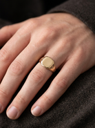 hand A gentleman's 18 carat gold signet ring. Cushion shaped head, plain and suitable for engraving, measures 11x11mm. Weight 7.2 grams.&nbsp;