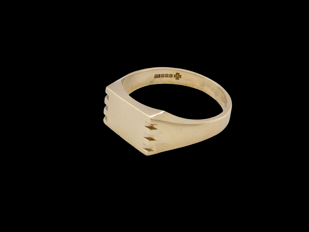 A gentleman's 9 carat gold signet ring. Rectangular shaped head,
