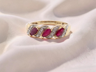 A gold dress ring. The three rubies are marquise cut, 5x3mm each, and set at an angle .