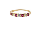 A half hoop 18 carat yellow gold eternity ring. Set with four bright red rubies, each 2.6mm (total carat weight 0.28 est)