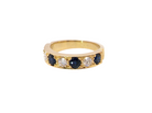 A half hoop ring. Features four dark ink blue black sapphires, each 3.6mm, and three brilliant cut white diamonds, each 3.6mm (est 0.15-0.17 carats each, total 0.50 carats est)
