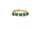 A half hoop ring, stamped 750 (testing as 18 carat gold)&nbsp;

Set with alternate gemstones, five bright green emeralds