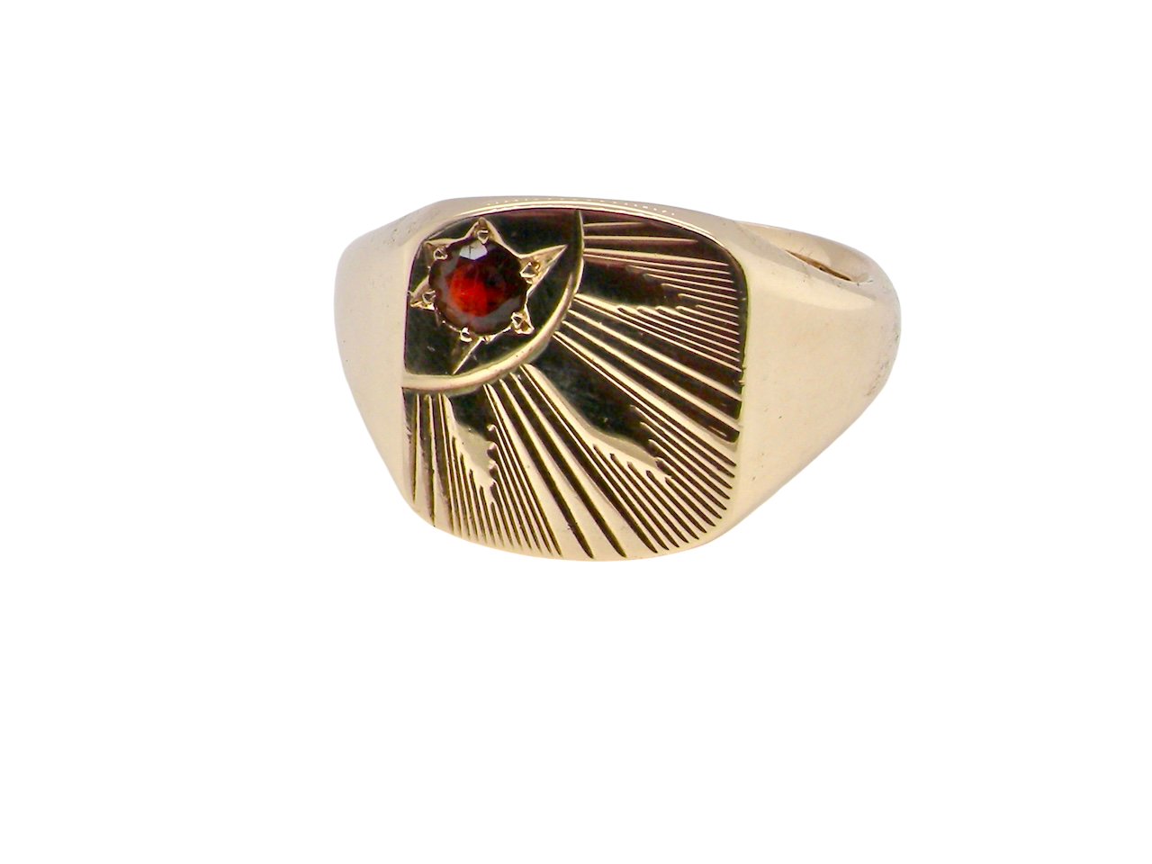 Gold ring with a red gemstone on a white background