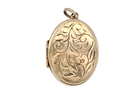 A large oval shaped locket. Measures 30x20mm. The front is hand engraved, .