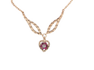 A late 1970s pendant/necklace. Features a heart shaped pendant that has a cluster set to its centre. Six small rubies 2.3mm each surround a diamond. Diamond cut outer rim.