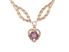 A late 1970s pendant/necklace. Features a heart shaped pendant that has a cluster set to its centre. Six small rubies 2.3mm each surround an illusion set diamond. 