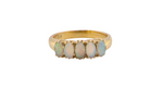 A lovely five stone ring. Set with five oval white opals, each 5x3.5mm, good play of colour on all.

Carved head 