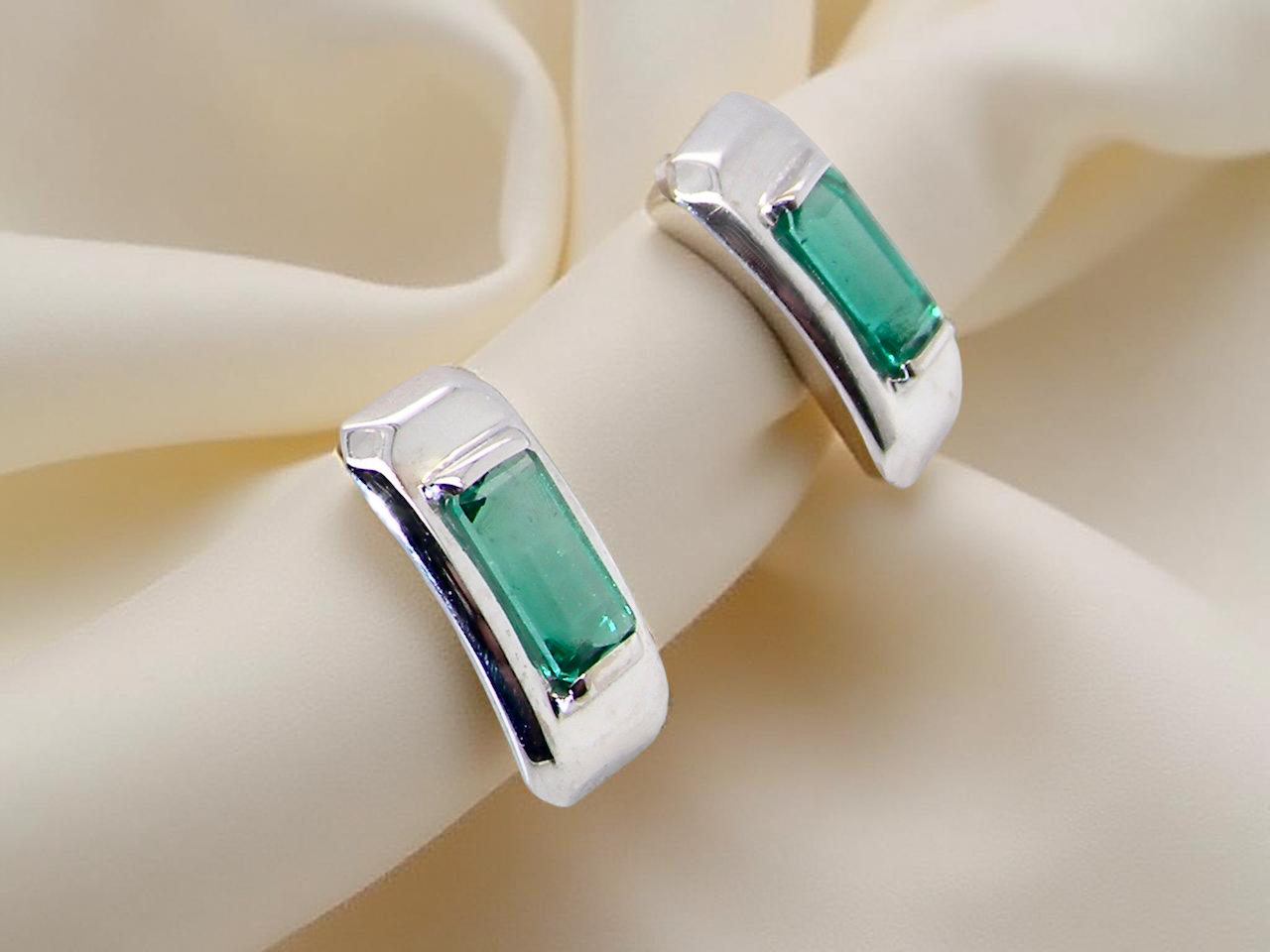 A lovely modern pair of earrings. Each emerald is rectangular, 