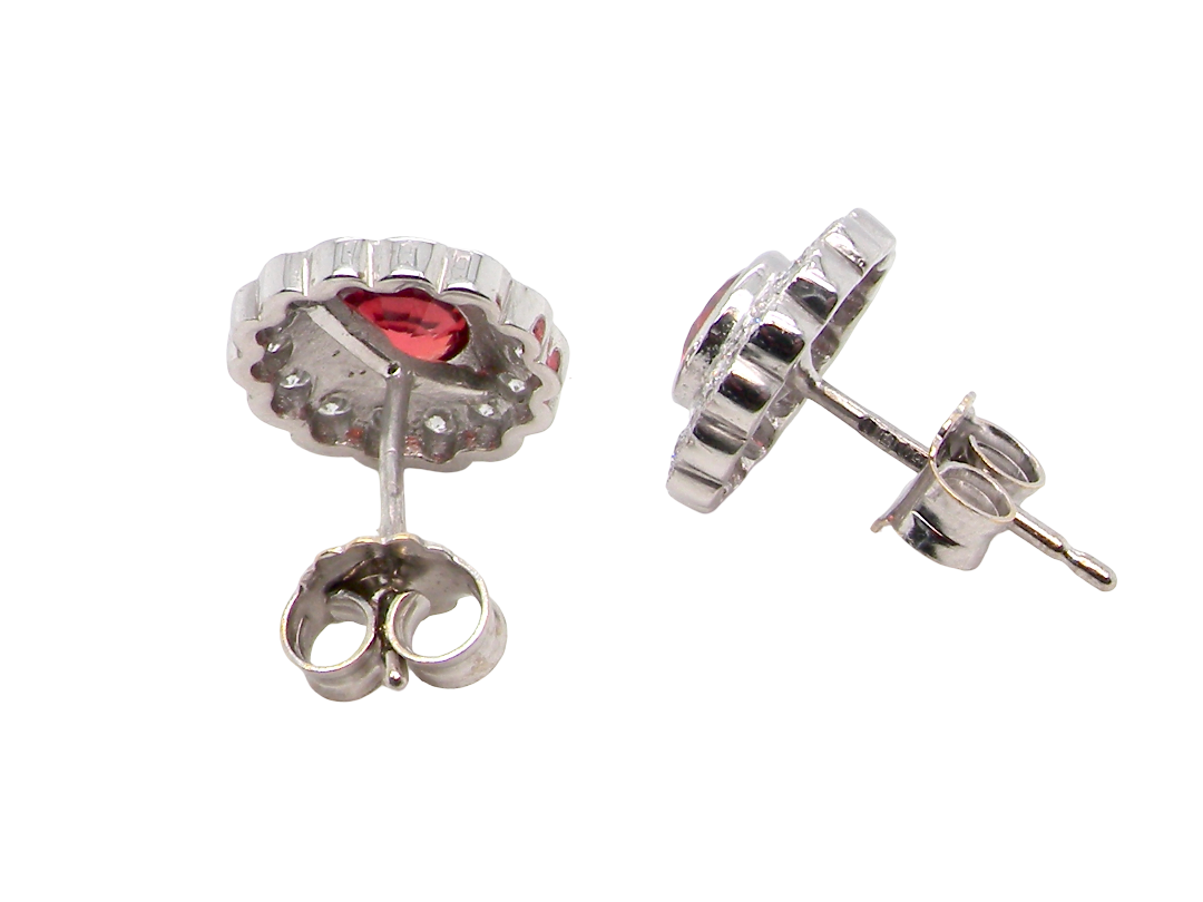 rear A lovely pair of stud earrings. Each features an unusual colour sapphire, fireglow orange. A deep orange hue, measures 5mm (est 0.50 carats)
