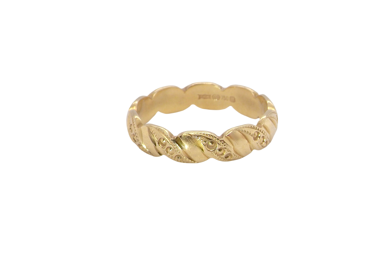 A lovely wedding ring, scalloped edges with dotted patterns around the body of the ring.