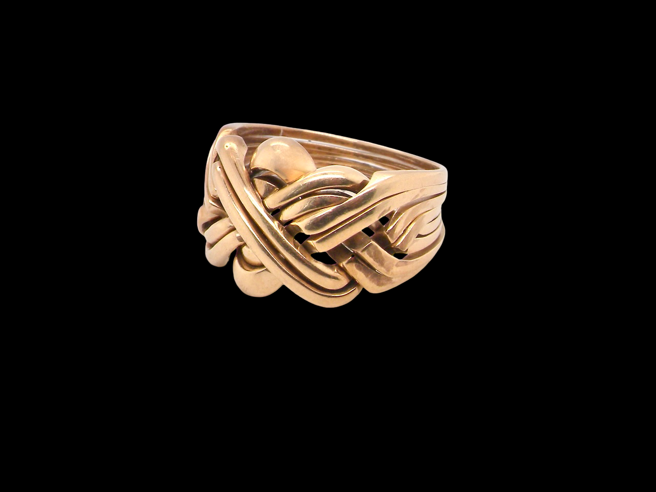 Gold ring with a unique design on a black background