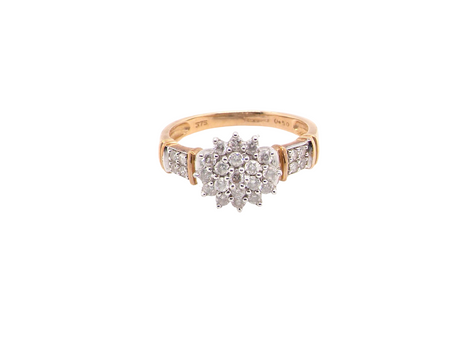 A modern 9 carat gold cluster ring featuring a round head fully set with nineteen brilliant-cut white diamonds,