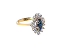 A navette shaped cluster ring. The centre a line of three sapphires, 0ne x 3.5mm, 2 x 1.5mm.
 side