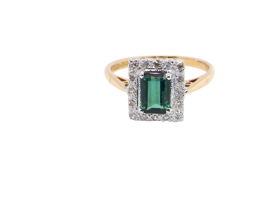 A near new cluster ring that shows no sign of wear, seems unworn.

Features a deep mint green tourmaline gemstone, 