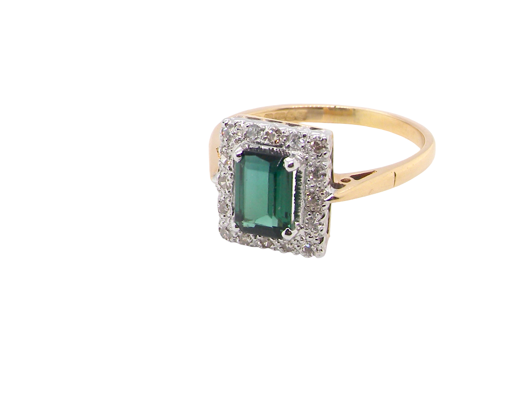 A near new cluster ring that shows no sign of wear, seems unworn.

Features a green tourmaline gemstone, 