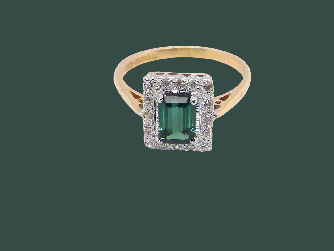 A near new cluster ring that shows no sign of wear, seems unworn.

Features a  mint green tourmaline gemstone, 