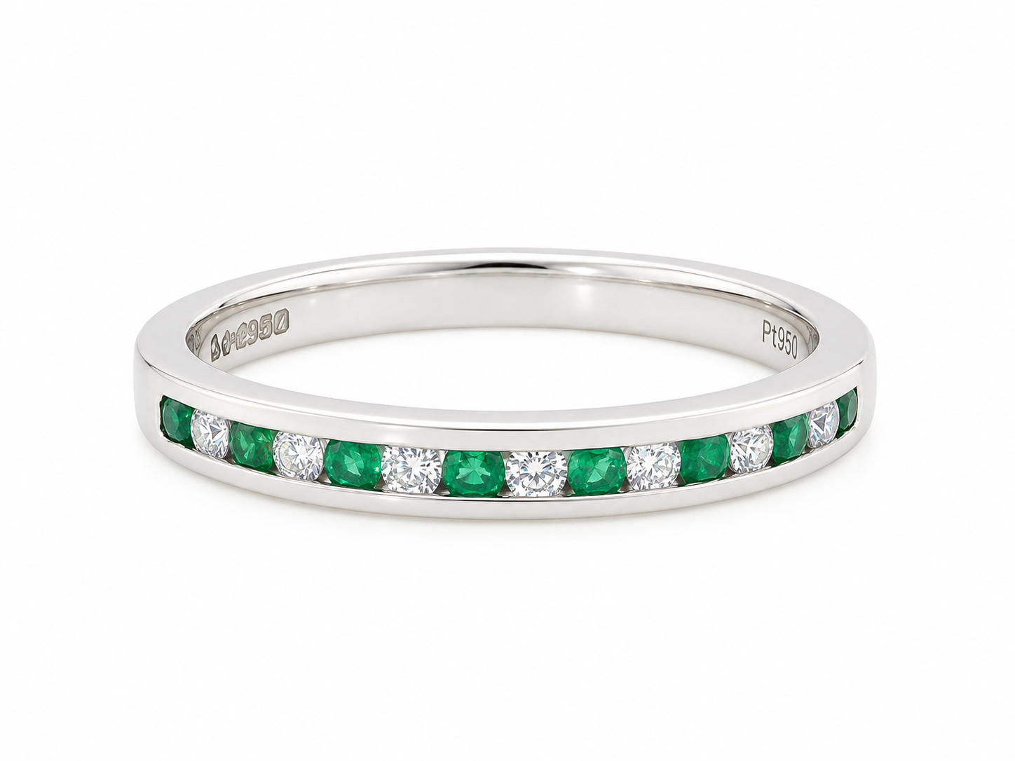 A ring featuring a channel setting of round-cut green emeralds and clear diamonds, shown on a plain white background.