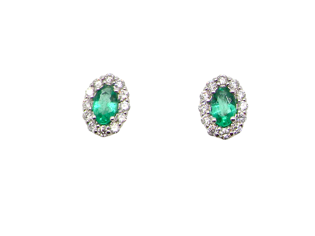 A pair of 18 carat white gold cluster earrings. The centre stone an oval cut emerald, 5x3.7mm (est 0.35 carats) deep green colour.