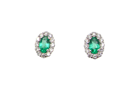 A pair of 18 carat white gold cluster earrings. The centre stone an oval cut emerald, 5x3.7mm (est 0.35 carats) deep green colour.