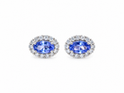 A pair of 18 carat white gold cluster earrings.&nbsp;

Features an oval tanzanite gemstone,