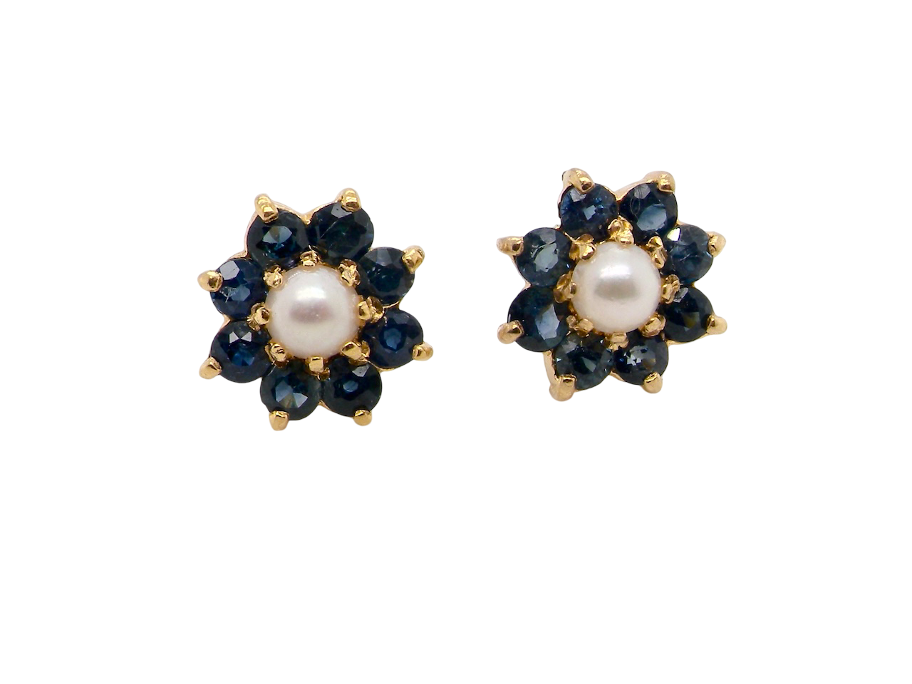 A pair of 9 carat gold cluster earrings. The centre set with a cultured pearl 4mm diameter. Surrounded by eight round sapphires, 
