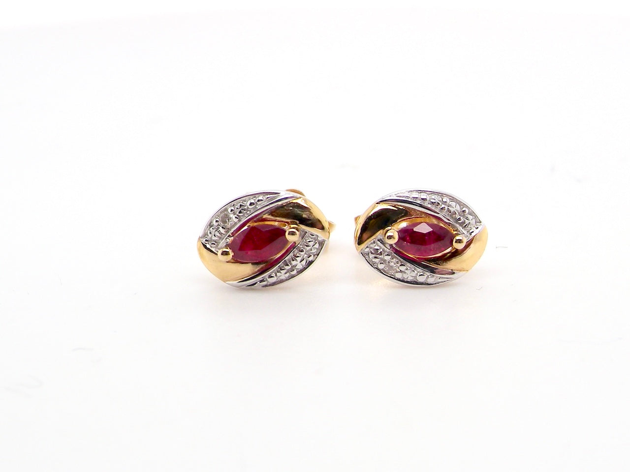 A pair of 9 carat gold earrings.

Centre stone an marquise cut ruby, 5x3mm