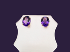 A pair of 9 carat gold stud earrings. Each earring an  amethyst stone,