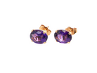 A pair of 9 carat gold stud earrings. Each earring an oval cut amethyst stone,