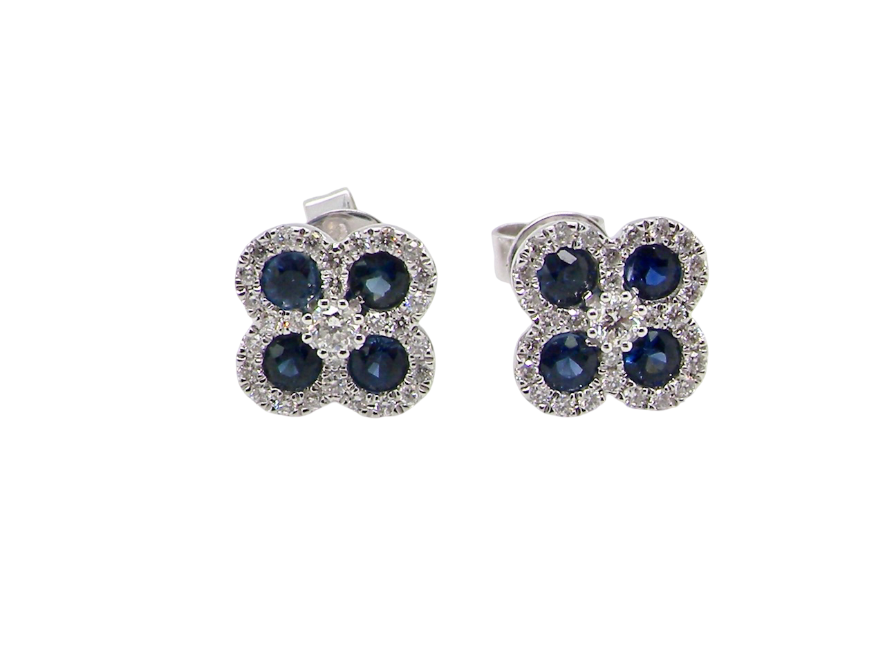 Pair of flower-shaped earrings with blue stones on a white background
