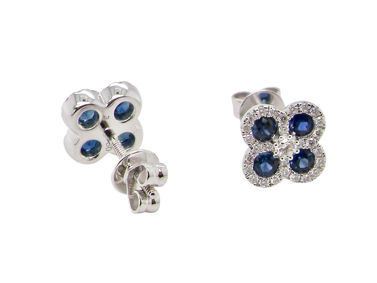 Pair of silver earrings with blue gemstones on a white background