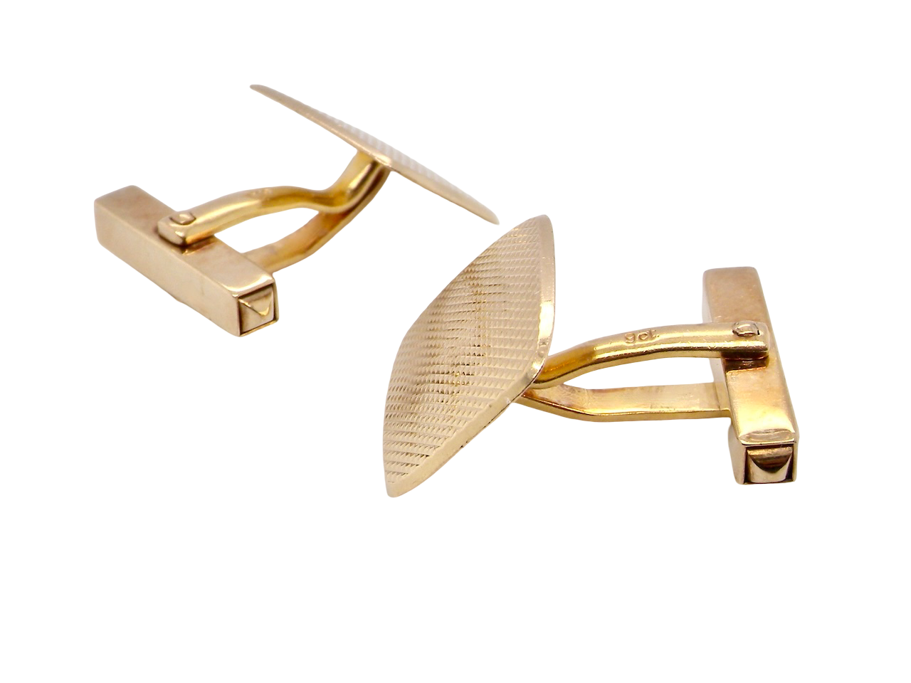 A pair of cushion shaped cufflinks. The head  engine turned pattern.
