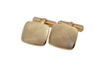 A pair of cushion shaped cufflinks. The head measures 17x15mm, engine turned pattern.
