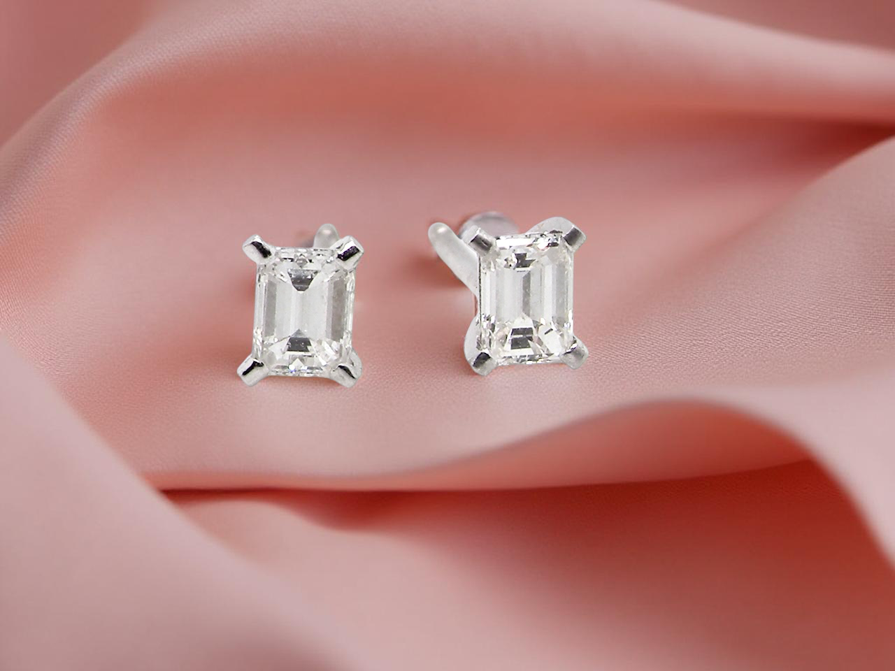 A pair of emerald cut diamond earrings